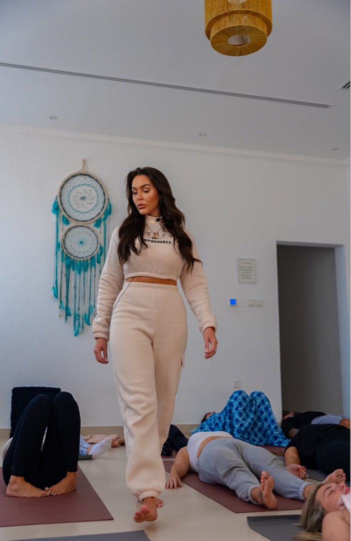 Shona walking through a breathwork class, guiding participants