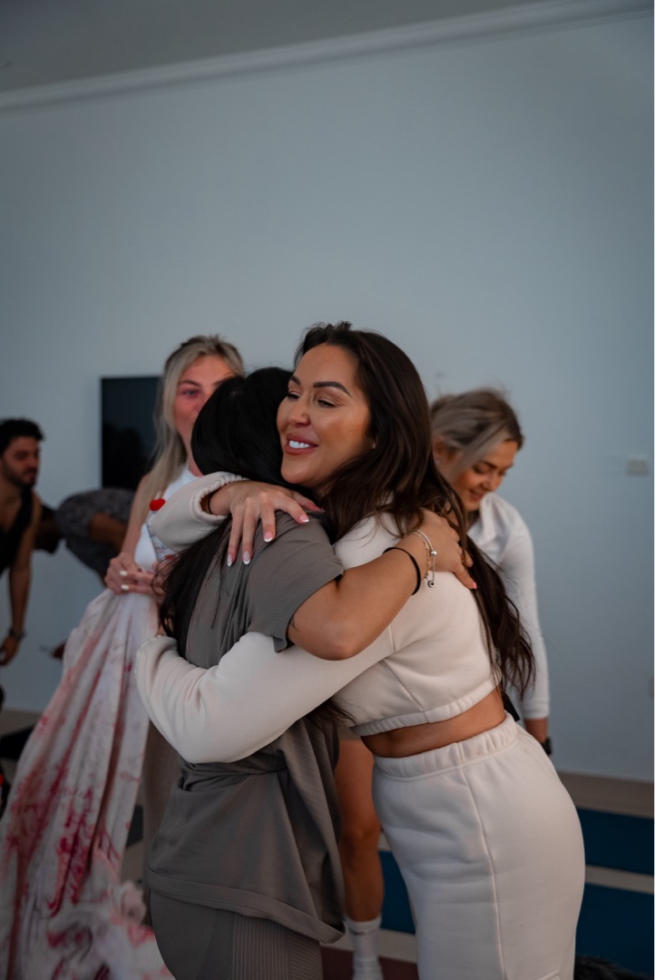 Shona meditating with eyes closed, wide shot of breathwork class