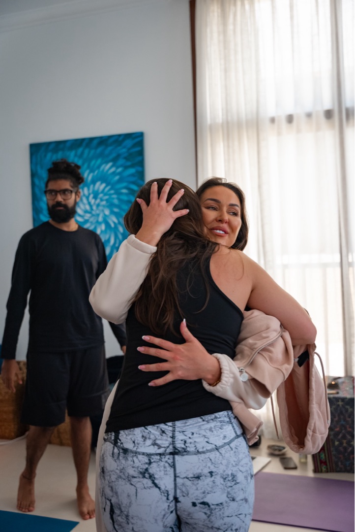 Shona with hands in prayer position guiding a breathwork session